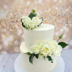 White wedding cake with white fresh flowers